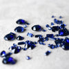 Sapphire Gemstones of various cuts scattered on a white background