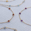 Five Bayberry 3 necklaces, each featuring three 4mm briolette cut, bezel set gemstones in 14k yellow gold. 
