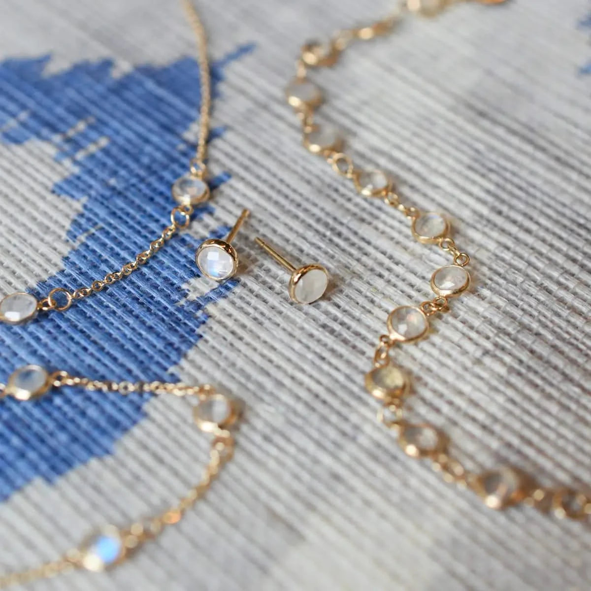 Assorted jewelry including a Newport necklace featuring 4 mm briolette cut moonstones bezel set in 14k yellow gold