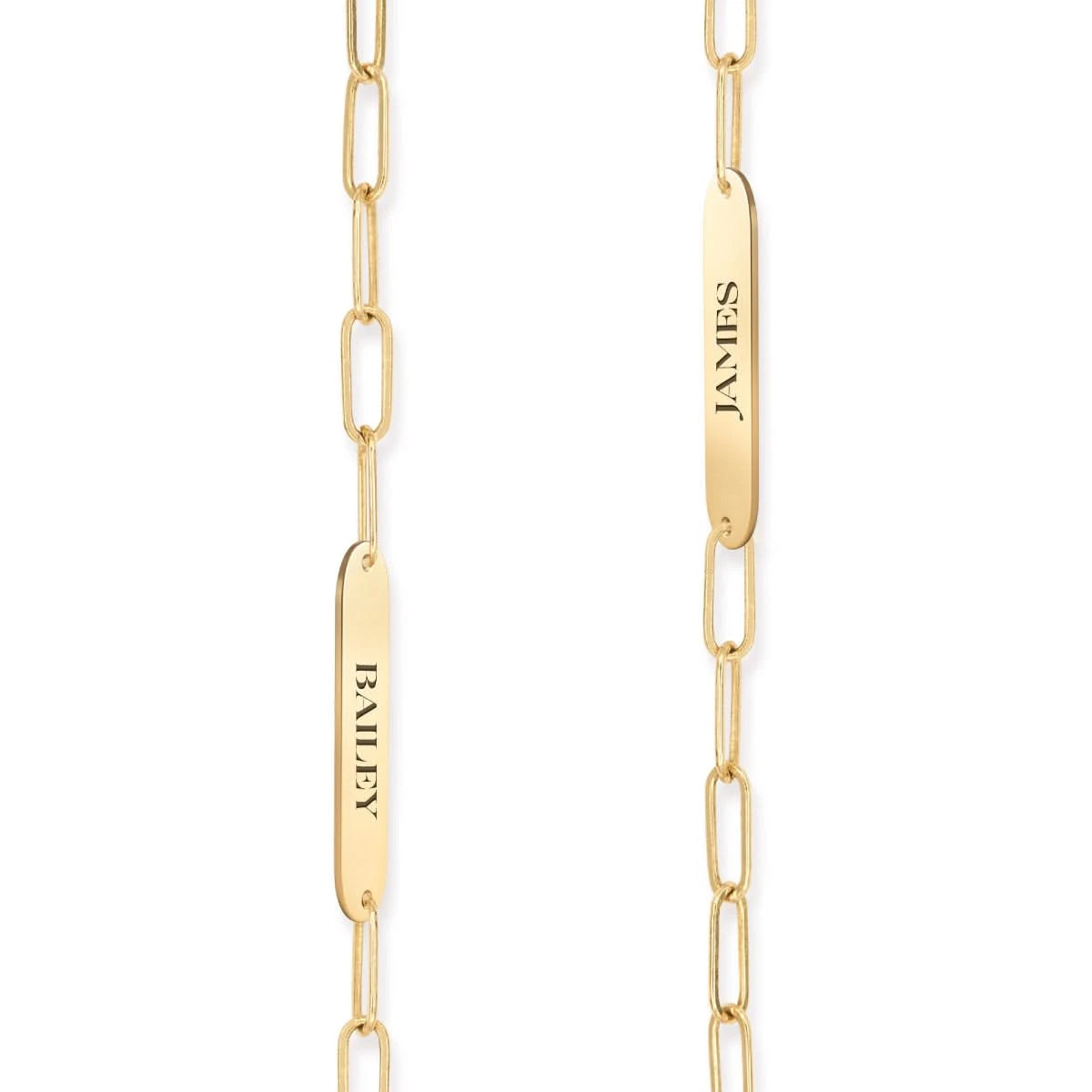 Detail of two 14k yellow gold flat nameplates engraved with the names Bailey and James, shown on Adelaide Mini chain links.
