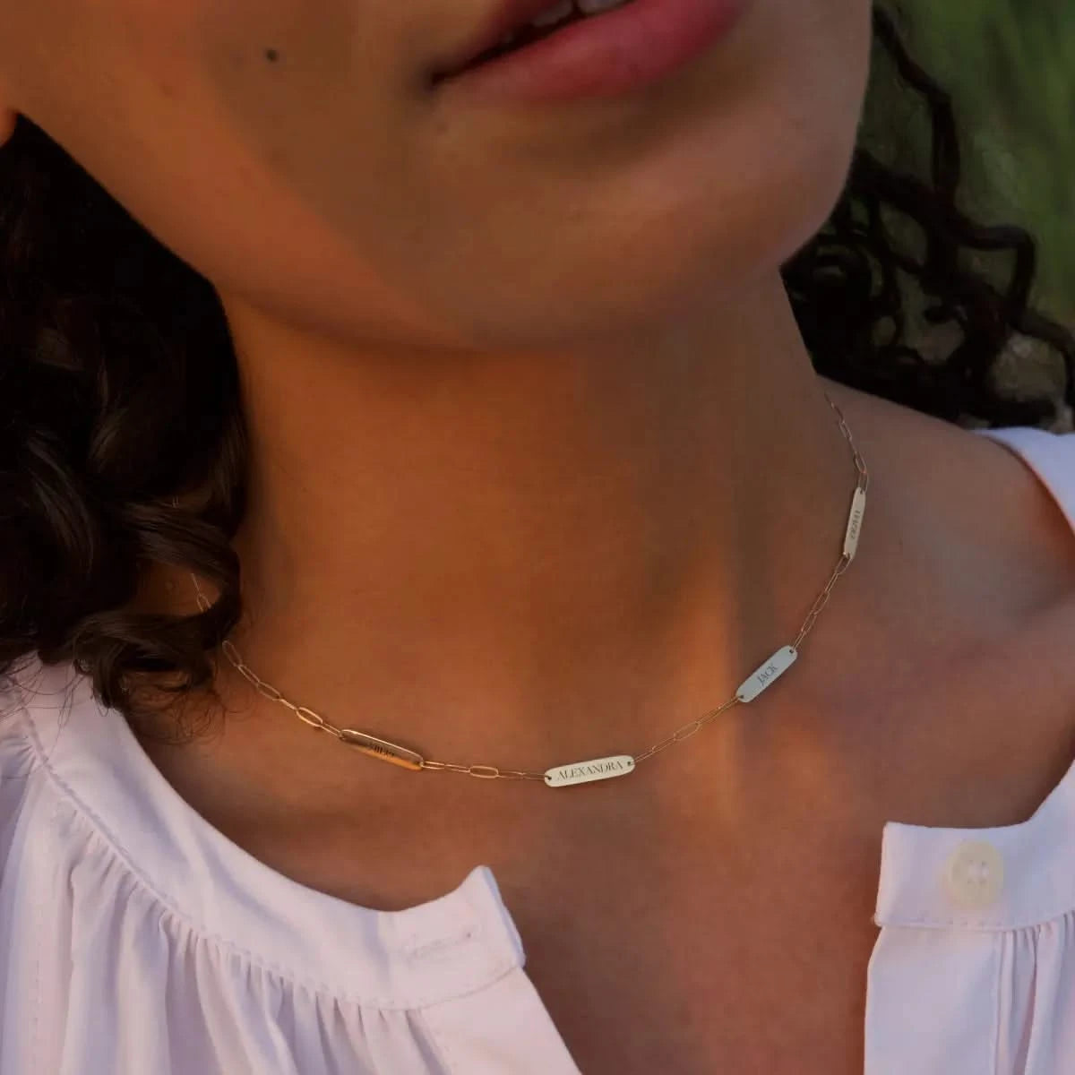 4 Petite Nameplate Necklace on Adelaide Mini paperclip chain in 14k yellow gold, , each 16.33 x 3.72 mm plate engraved with children’s names.
