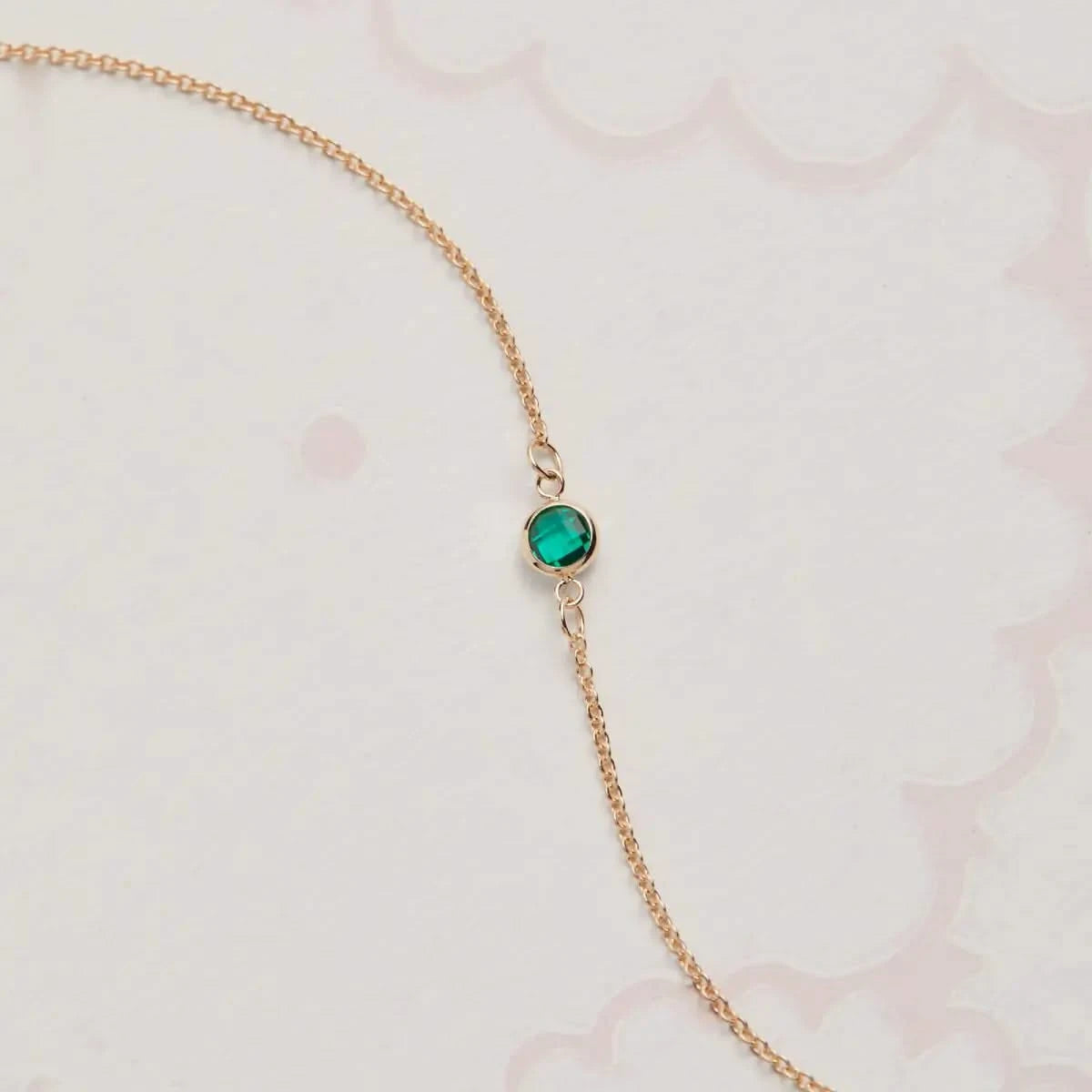 Petite 1 Emerald Bracelet features a single 4 mm bezel-set Emerald birthstone in 14k gold, perfect for everyday wear and layering.