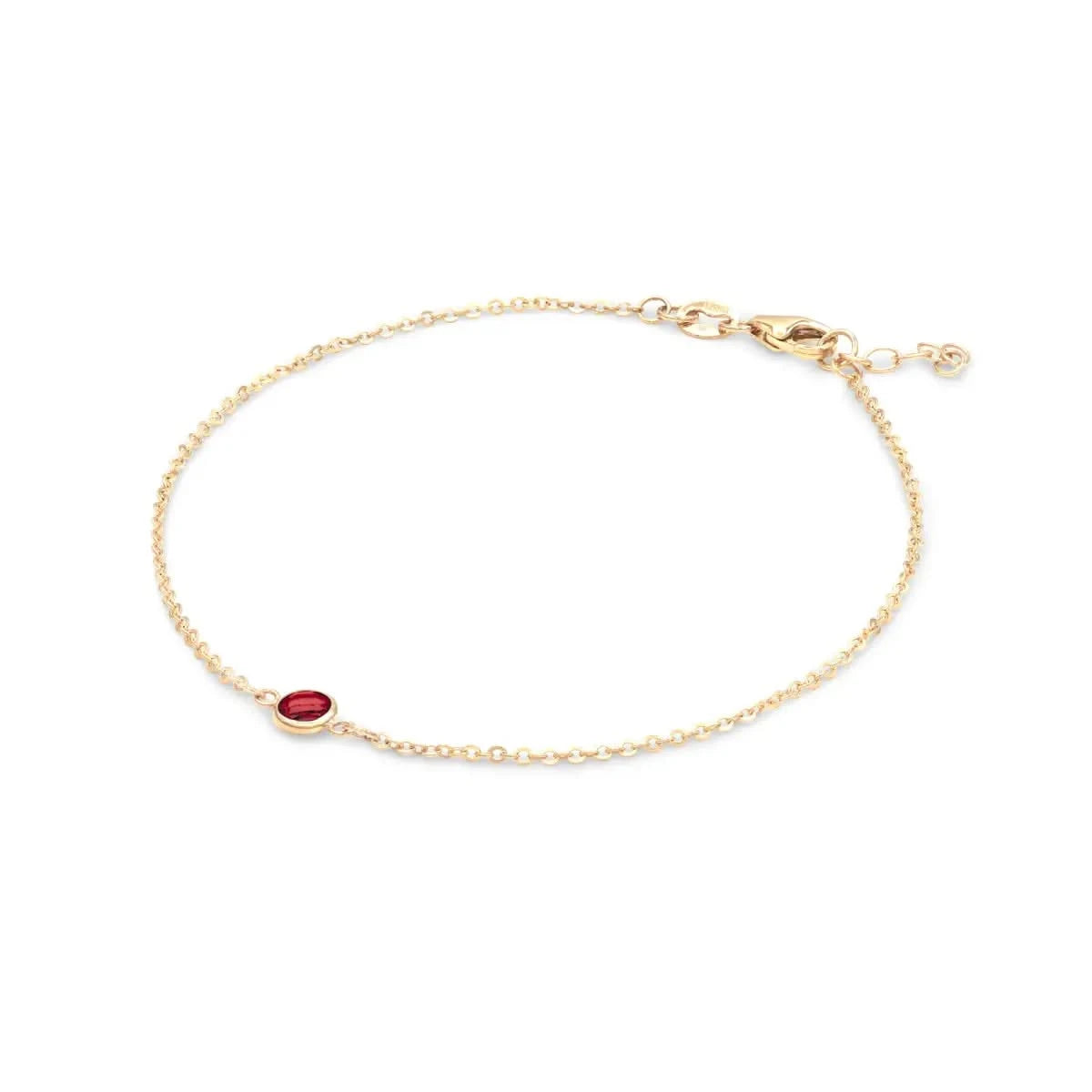 Classic cable chain bracelet featuring one 4 mm briolette cut garnet bezel set in 14k yellow gold - angled view