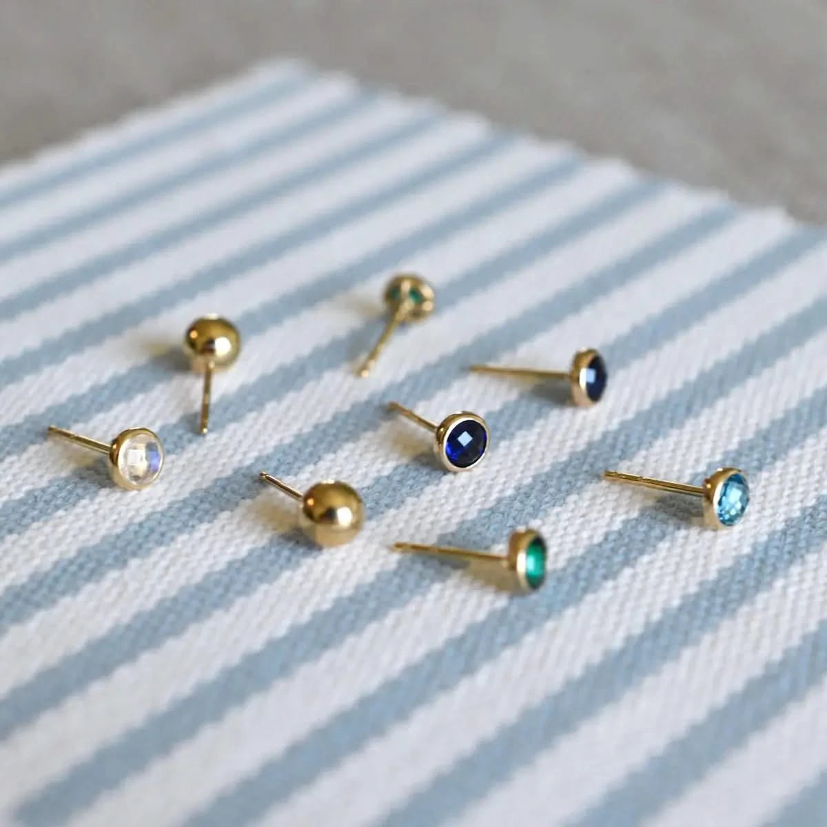 Petite Birthstone Stud Earrings featuring 4 mm briolette cut gemstone bezel set in 14k yellow gold
