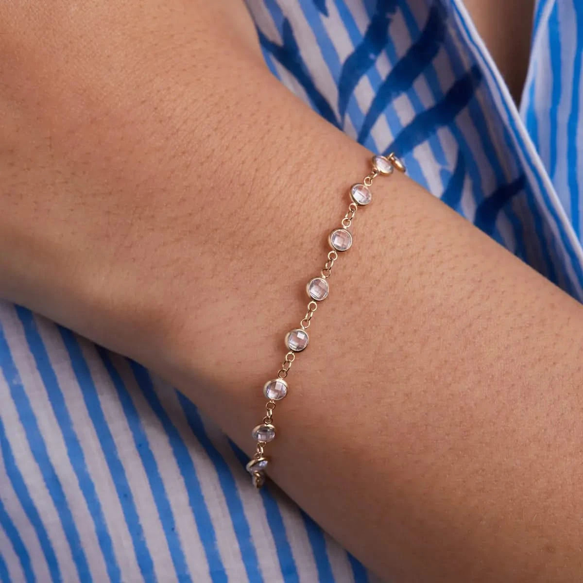 Close-up of the Newport White Topaz Bracelet in 14k gold showing individual round bezel set stones.