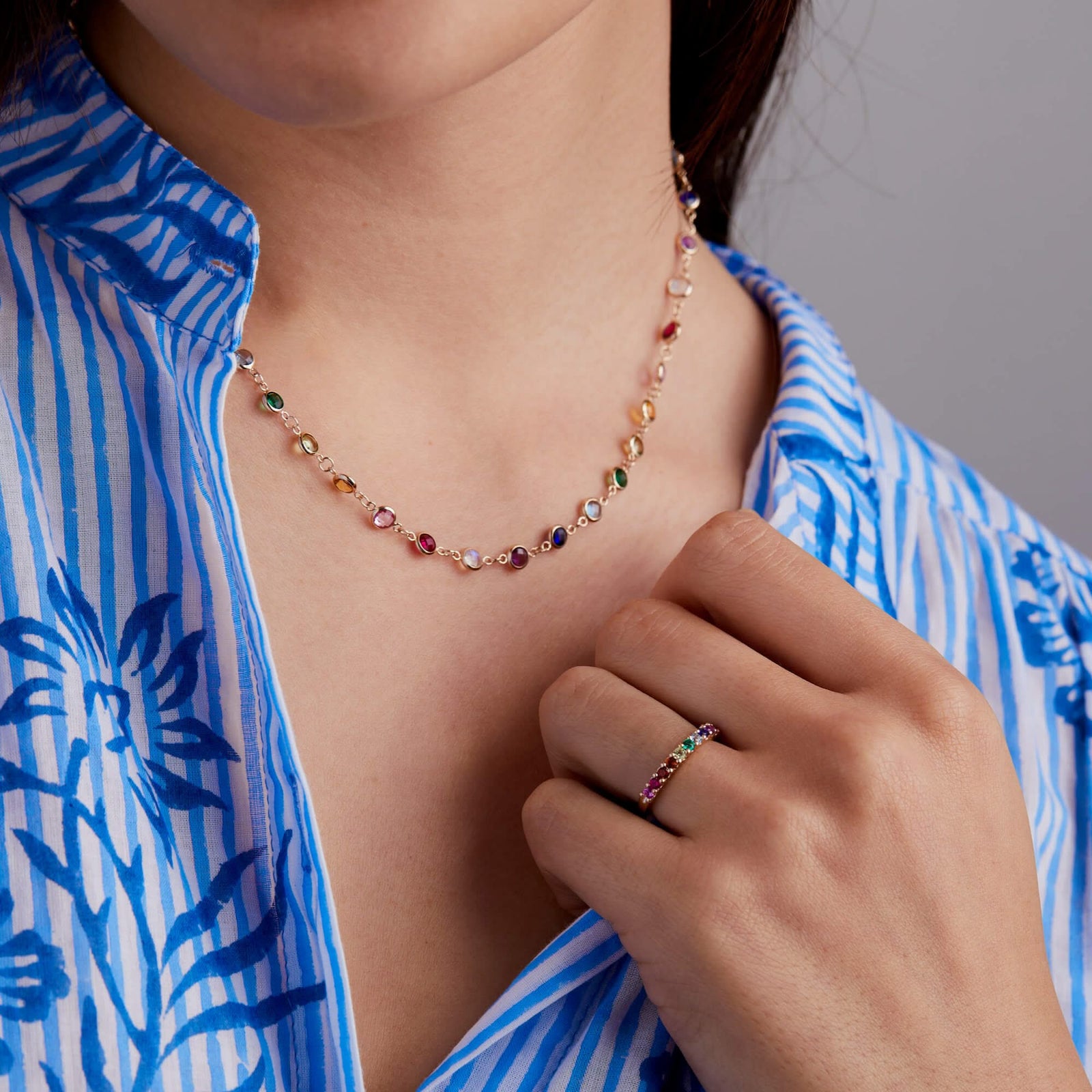 Woman wearing Rainbow Newport Necklace and Rosecliff stackable ring with 2mm rubies, citrines, emeralds, sapphires, amethysts, pink sapphires