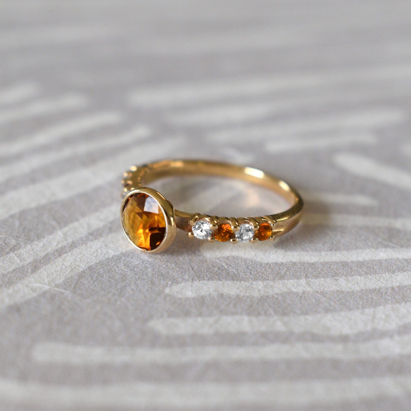 14k gold Rosecliff Grand Ring showcasing a 6 mm round, briolette-cut Citrine and eight alternating 2 mm round-cut Diamonds and Citrines.