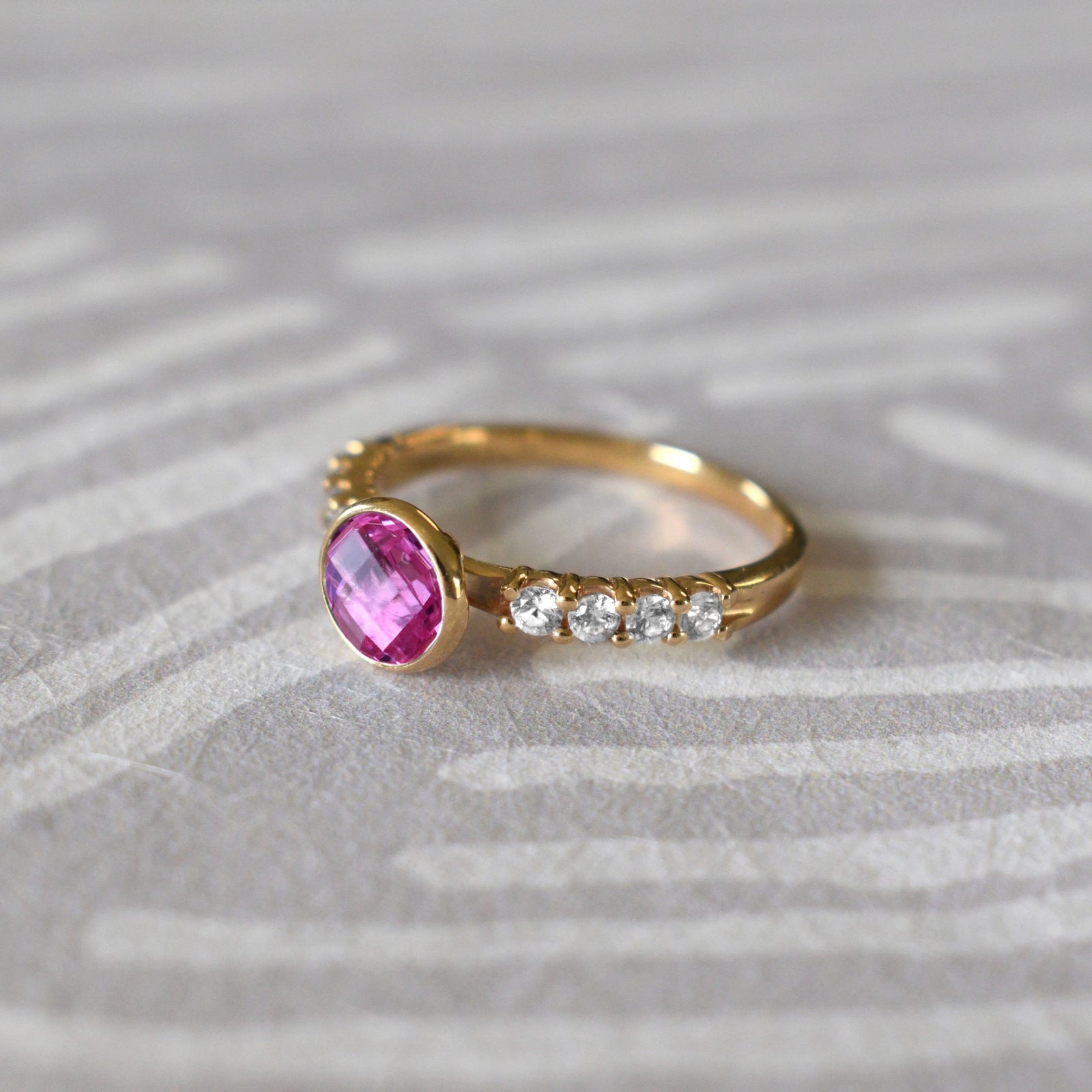 14k gold rings, including a 14k gold Rosecliff Grand Ring with a 6 mm briolette-cut Pink Sapphire and eight smaller 2 mm round-cut Diamonds.