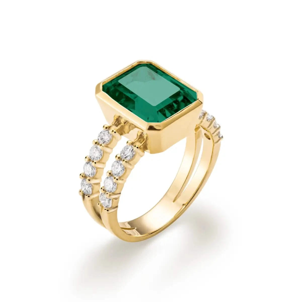 Warren ring in 14k yellow gold with accent diamonds featuring one 10 x 8 mm emerald cut bezel set emerald - aspect view