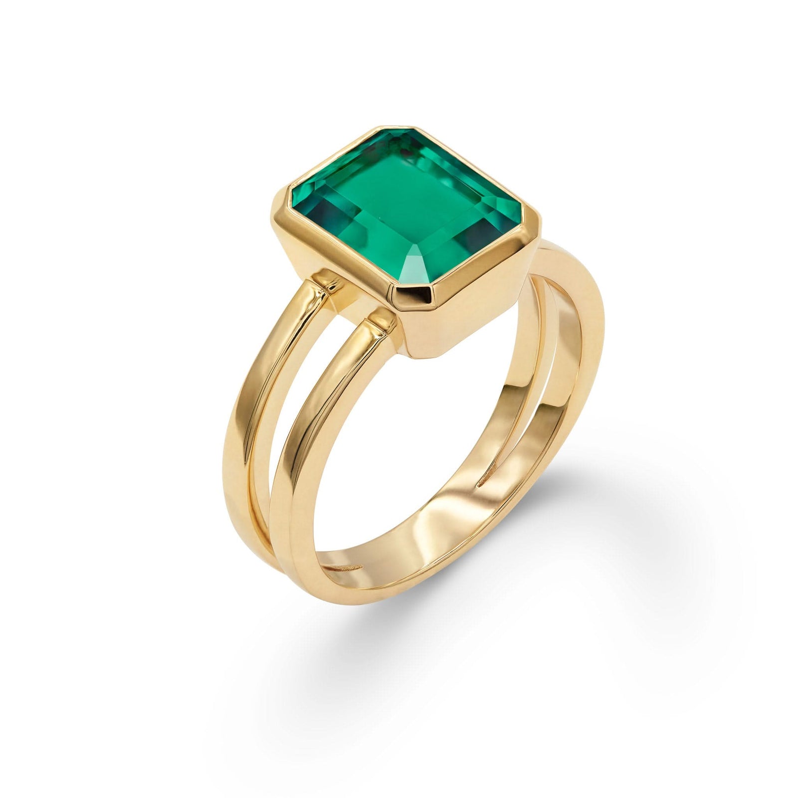 Warren ring in 14k yellow gold featuring one 10 x 8 mm emerald cut bezel set emerald - aspect view
