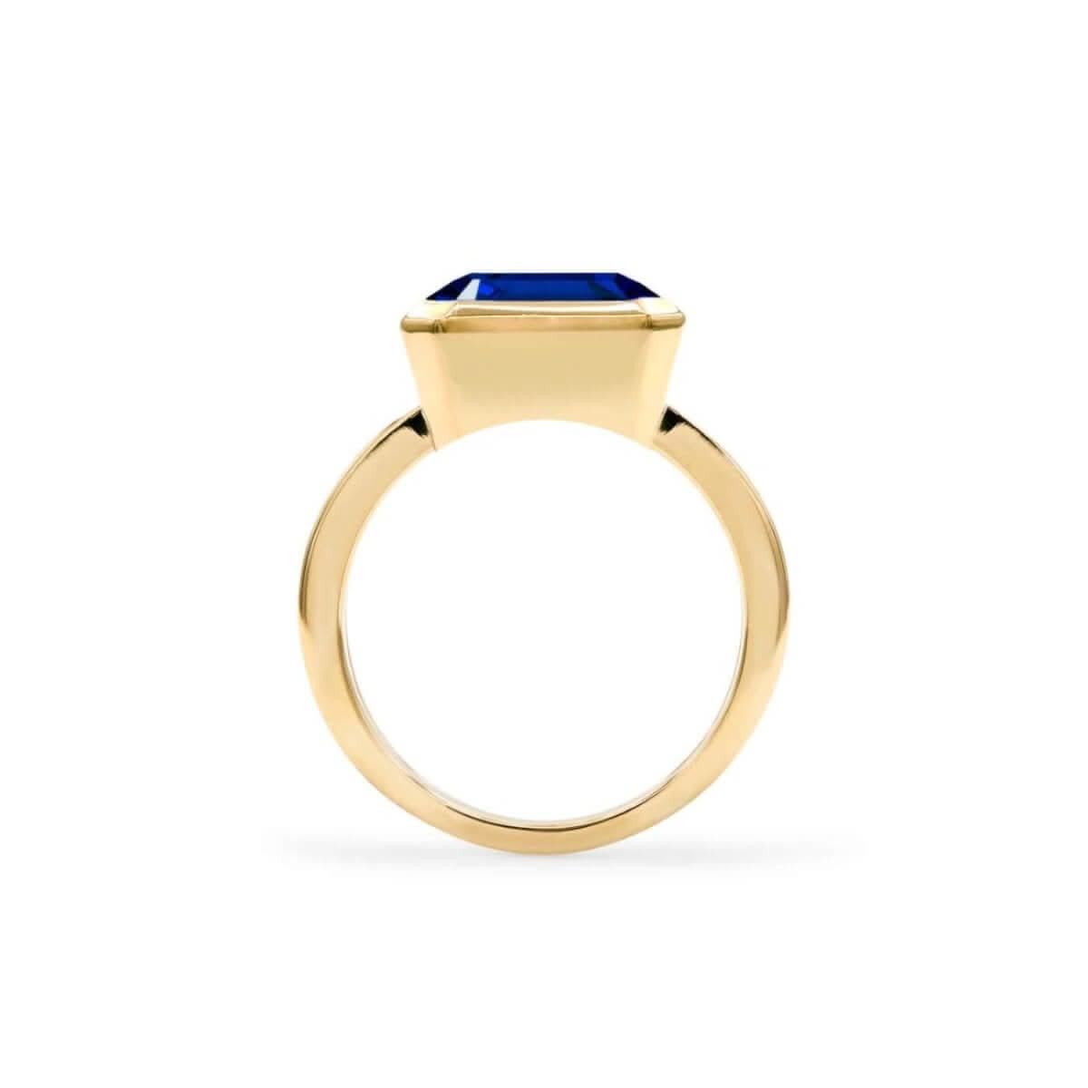 Warren Horizontal Sapphire Ring, featuring an emerald-cut 8 x 10mm sapphire in 14k gold, hand-set horizontally in a 14k-gold bezel - standing view.