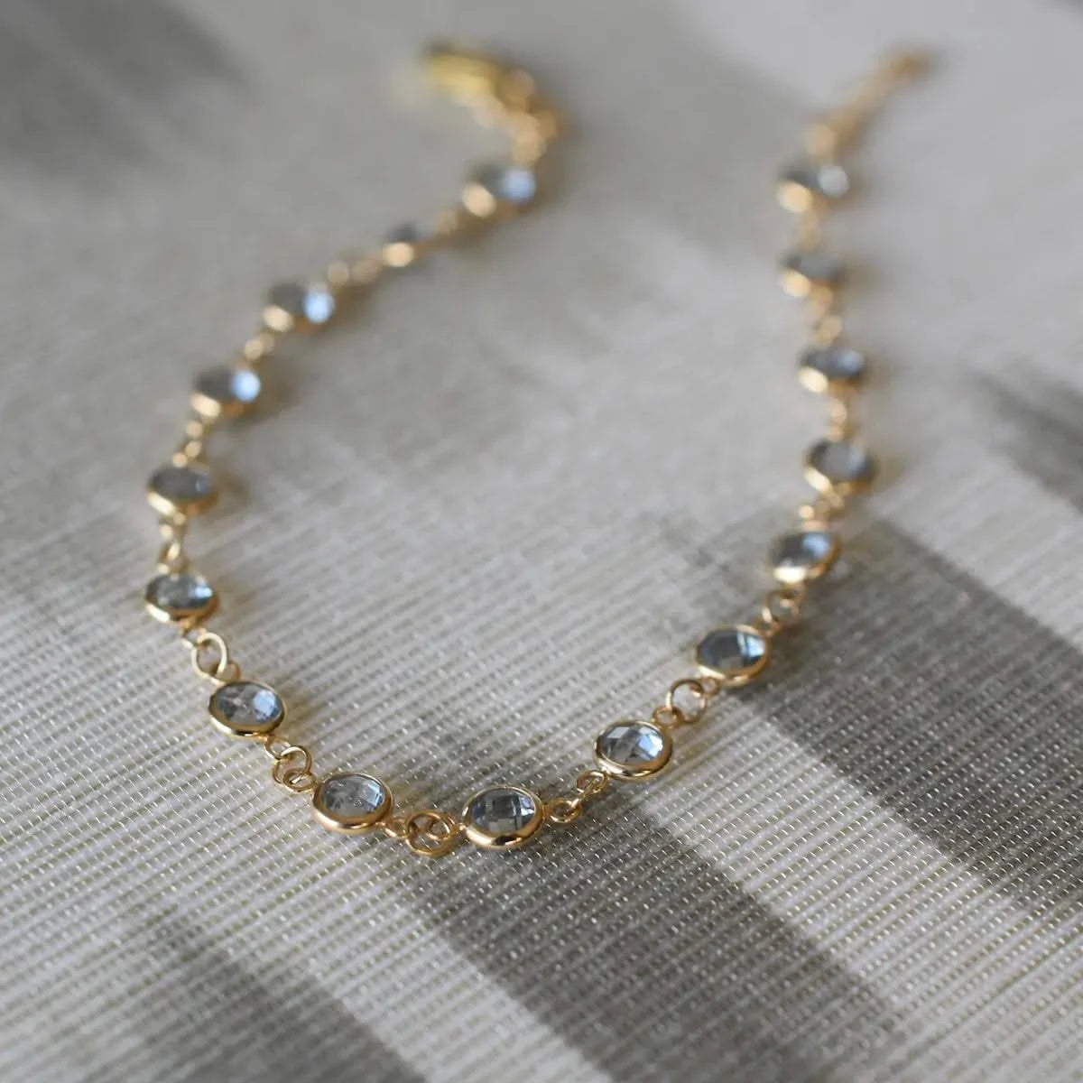 Newport Aquamarine Bracelet in 14k gold laid flat to show the full arrangement of bezel set gemstones.