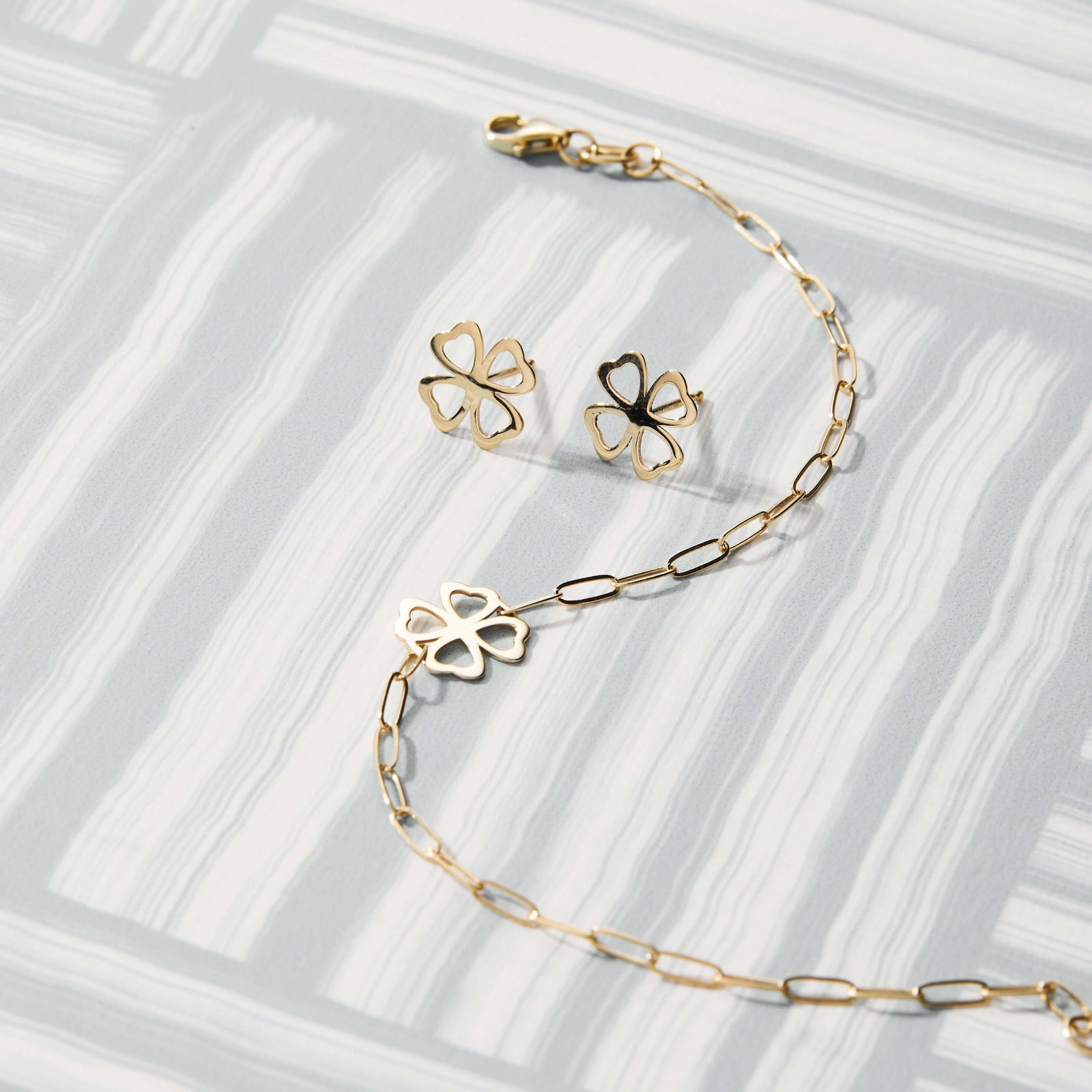 Assorted jewerly featuring Clover Stud Earrings in 14k yellow gold bringing good luck, featuring 9.1mm cutout clover.