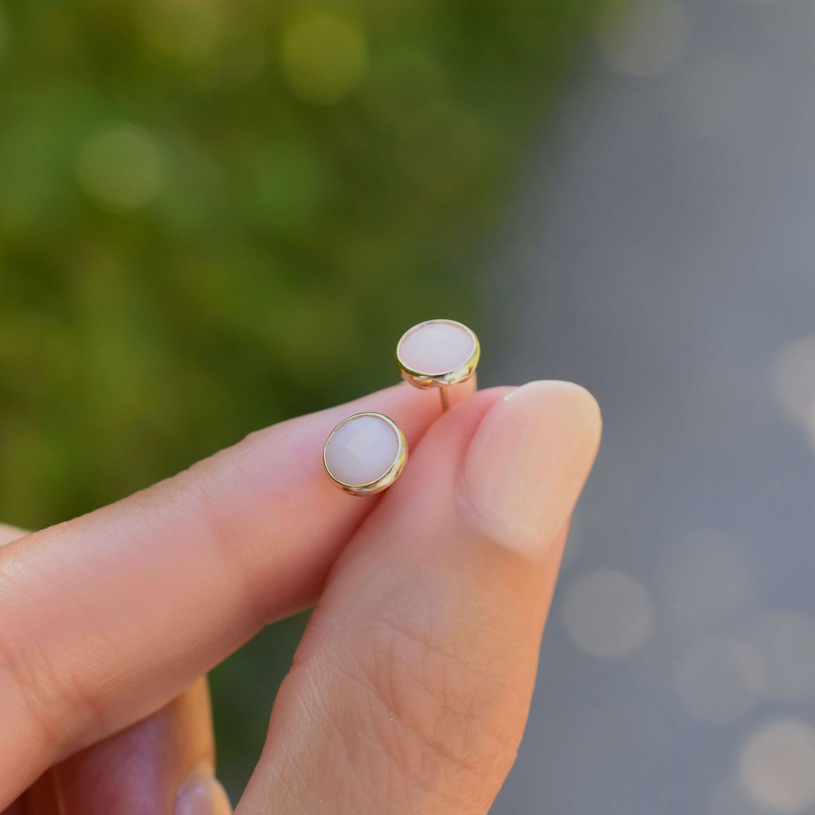 A pair of 14k yellow gold Grand stud earrings each featuring one 6 mm briolette cut Pink Opal