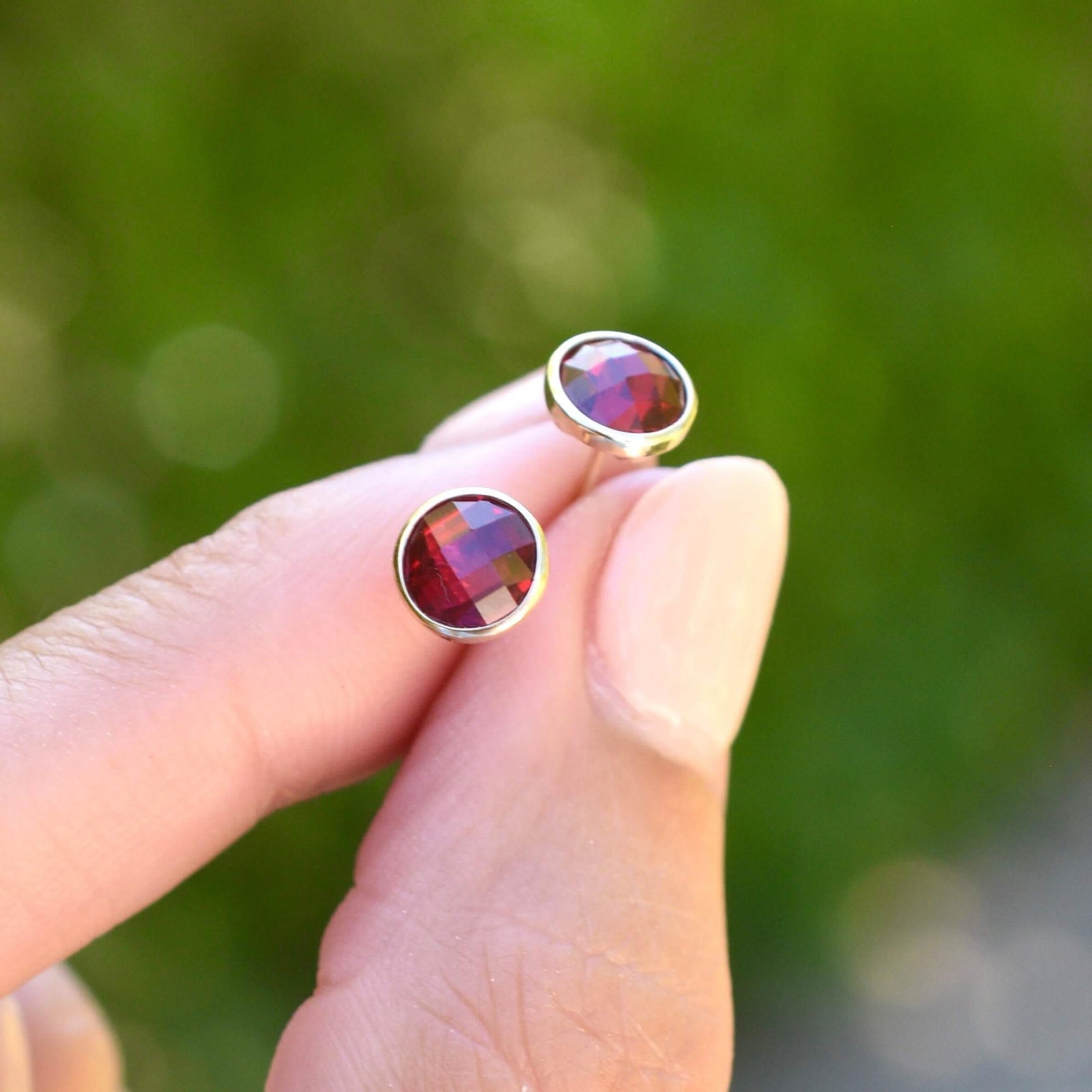 A pair of 14k yellow gold Grand stud earrings each featuring one 6 mm briolette cut Rubies