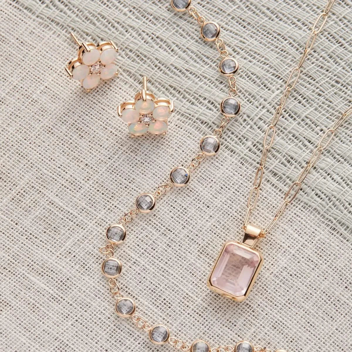 Newport Aquamarine necklace styled with opal earrings and pink gemstone pendant.