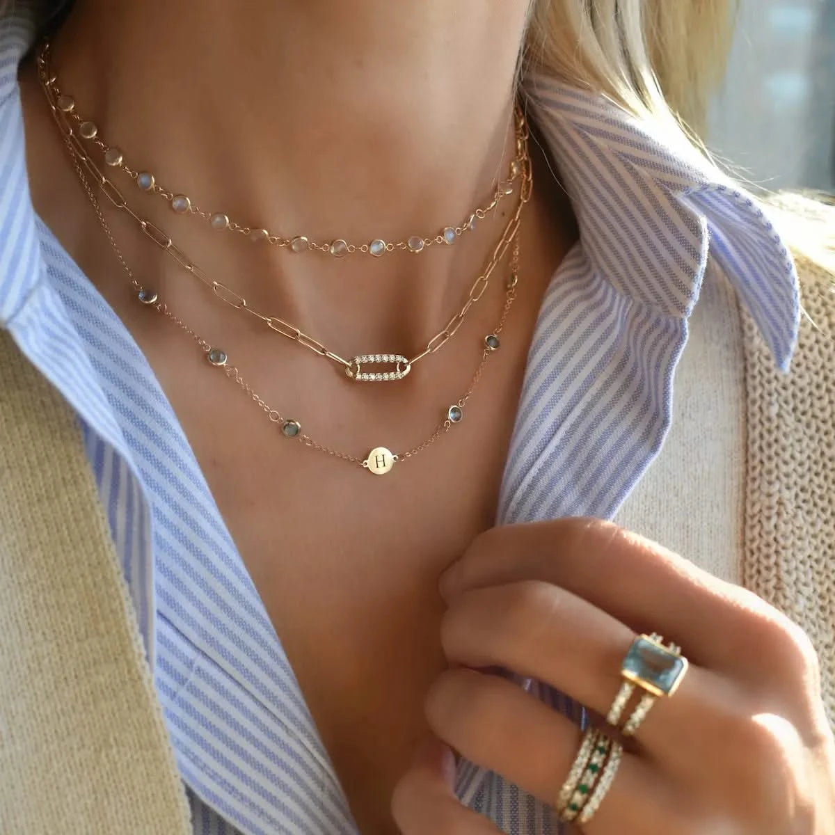 Layered look with the Newport Moonstone Necklace styled with gold Pavé Birthstone Link Necklace and personalized Letter Necklace with Blue Topaz stones.