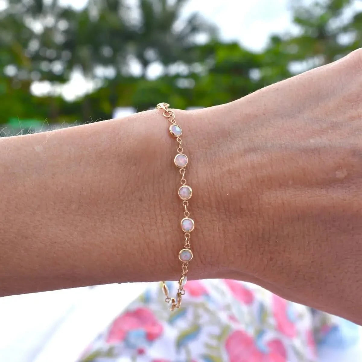 Newport Opal Bracelet worn alone on wrist outdoors, highlighting opal sparkle.