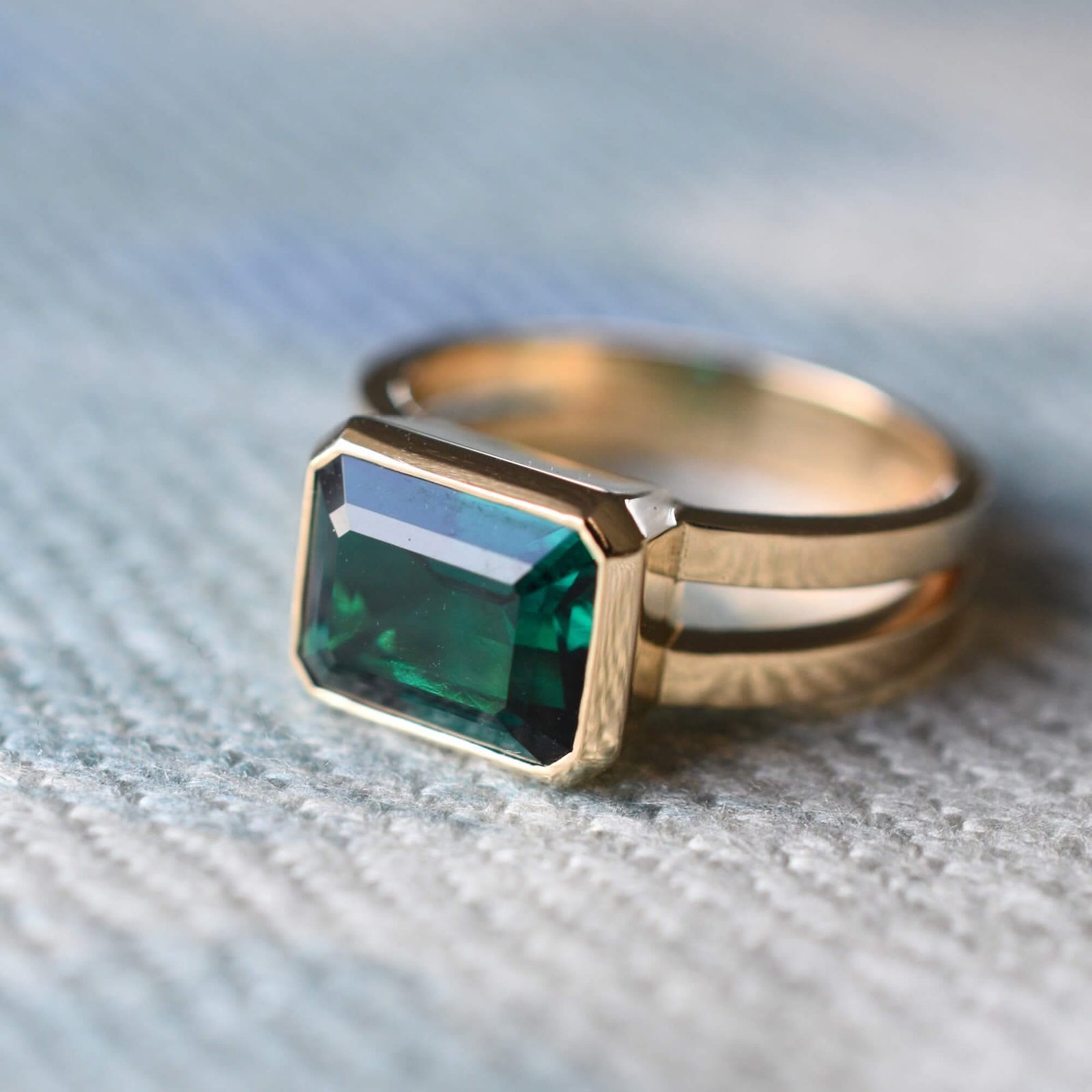 Warren Horizontal Emerald Ring, featuring an emerald-cut 8 x 10mm Emerald in 14k gold, hand-set horizontally in a 14k-gold bezel.