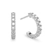 A pair of Rosecliff huggie earrings in 14k white gold each featuring nine 2mm faceted round cut prong set white topaz