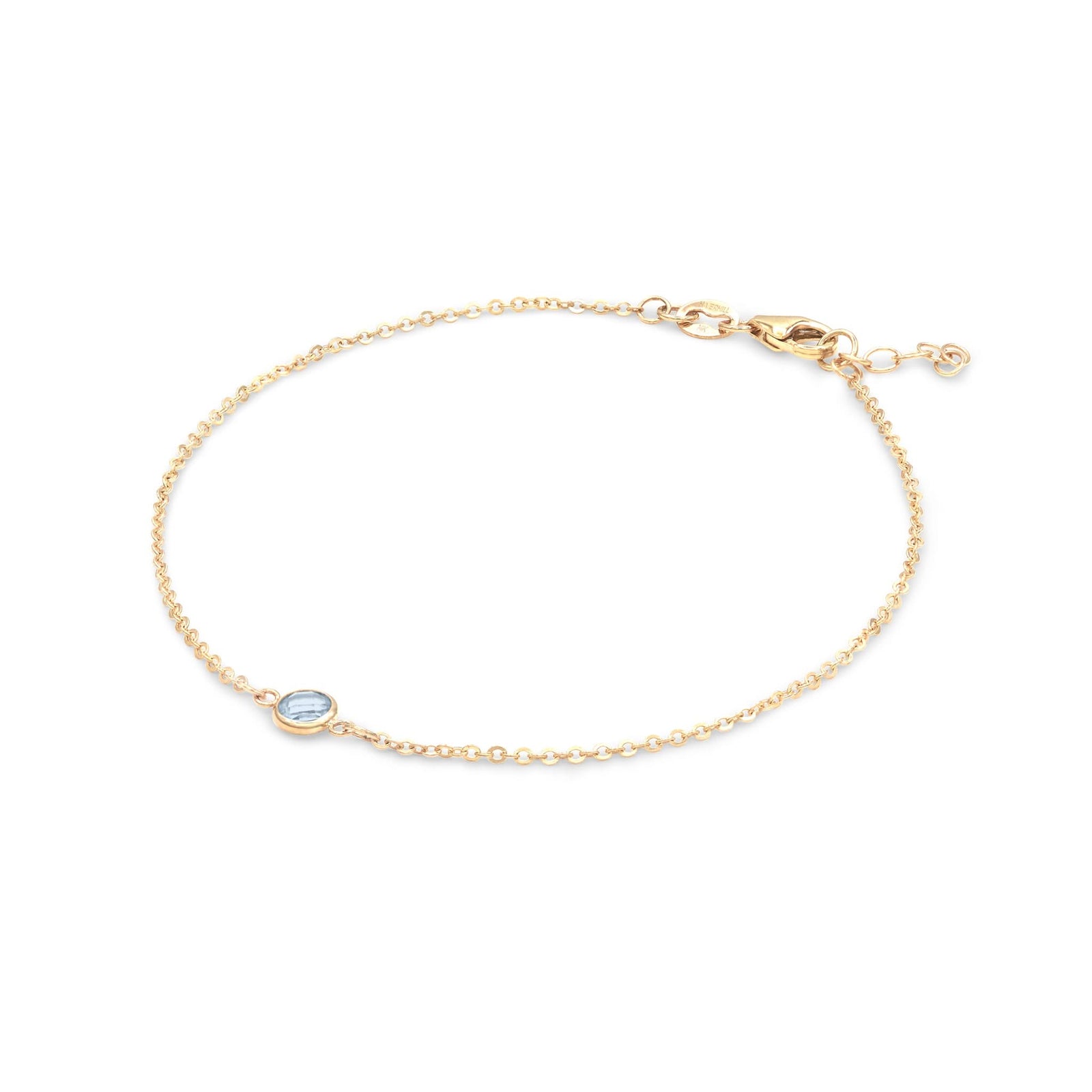 Classic cable chain bracelet featuring one 4 mm briolette cut aquamarine bezel set in 14k yellow gold - angled view