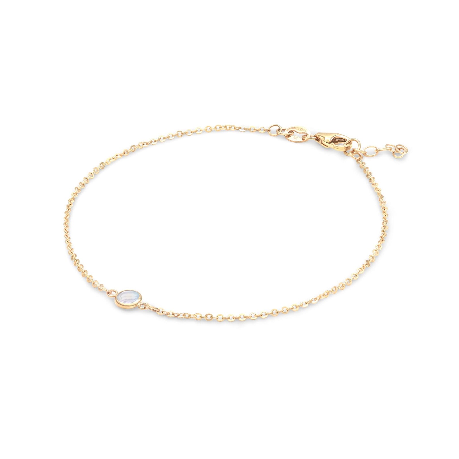 Classic cable chain bracelet featuring one 4 mm briolette cut moonstone bezel set in 14k yellow gold - angled view