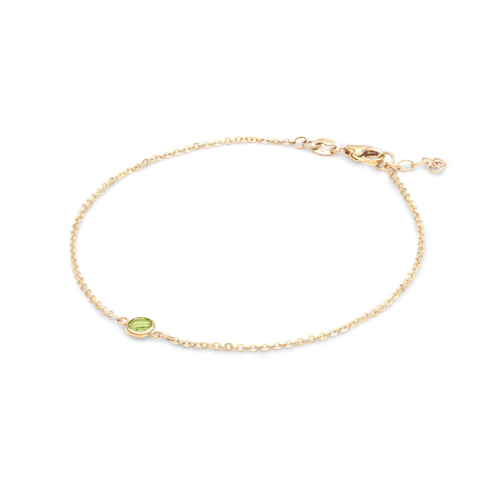 Classic cable chain bracelet featuring one 4 mm briolette cut peridot bezel set in 14k yellow gold - angled view