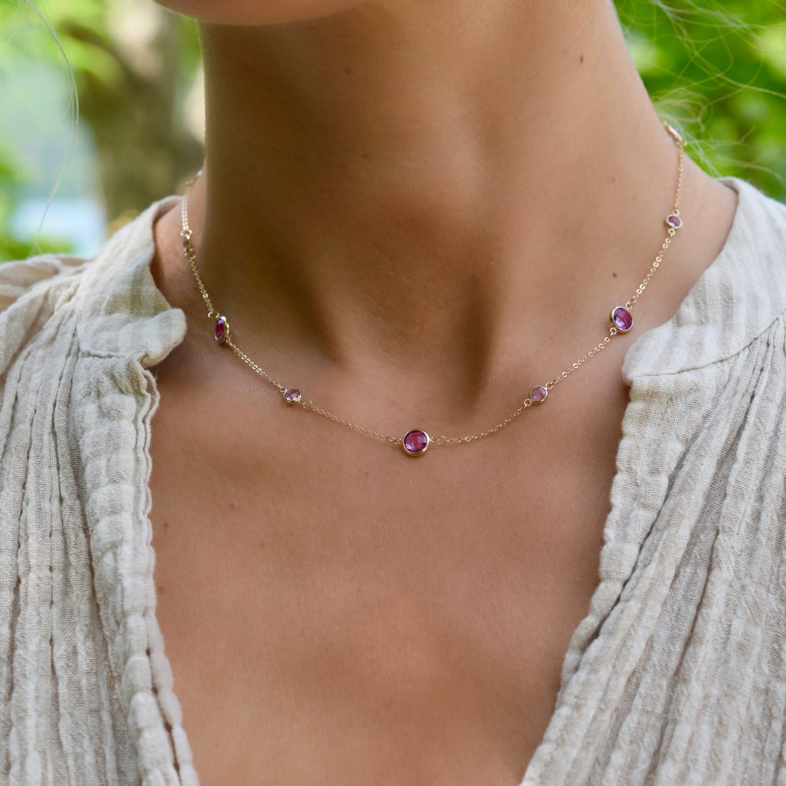 Woman with a Bayberry Grand & Classic 14k gold necklace featuring alternating 4 mm & 6 mm pink tourmalines & pink sapphires