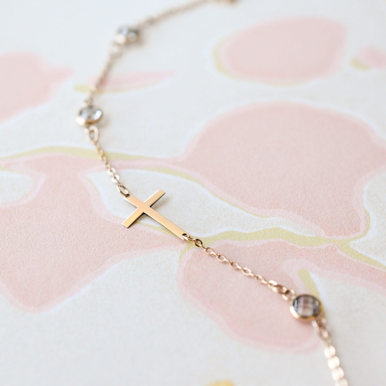 14k yellow gold Classic cable chain bracelet featuring birthstones and a 1/2" cutout cross