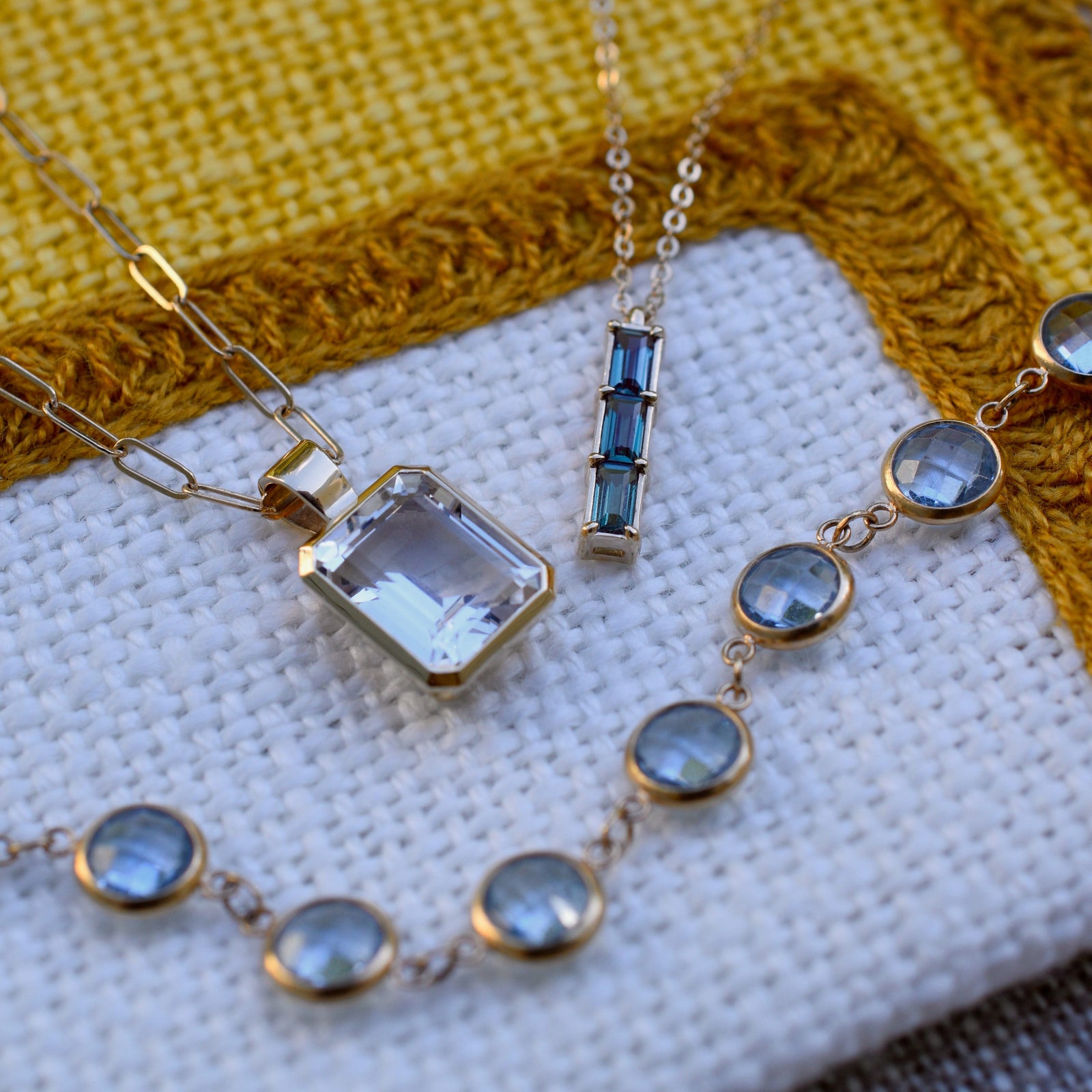 Assorted jewelry featuring the Providence 3 Alexandrite Pendant in 14k yellow gold