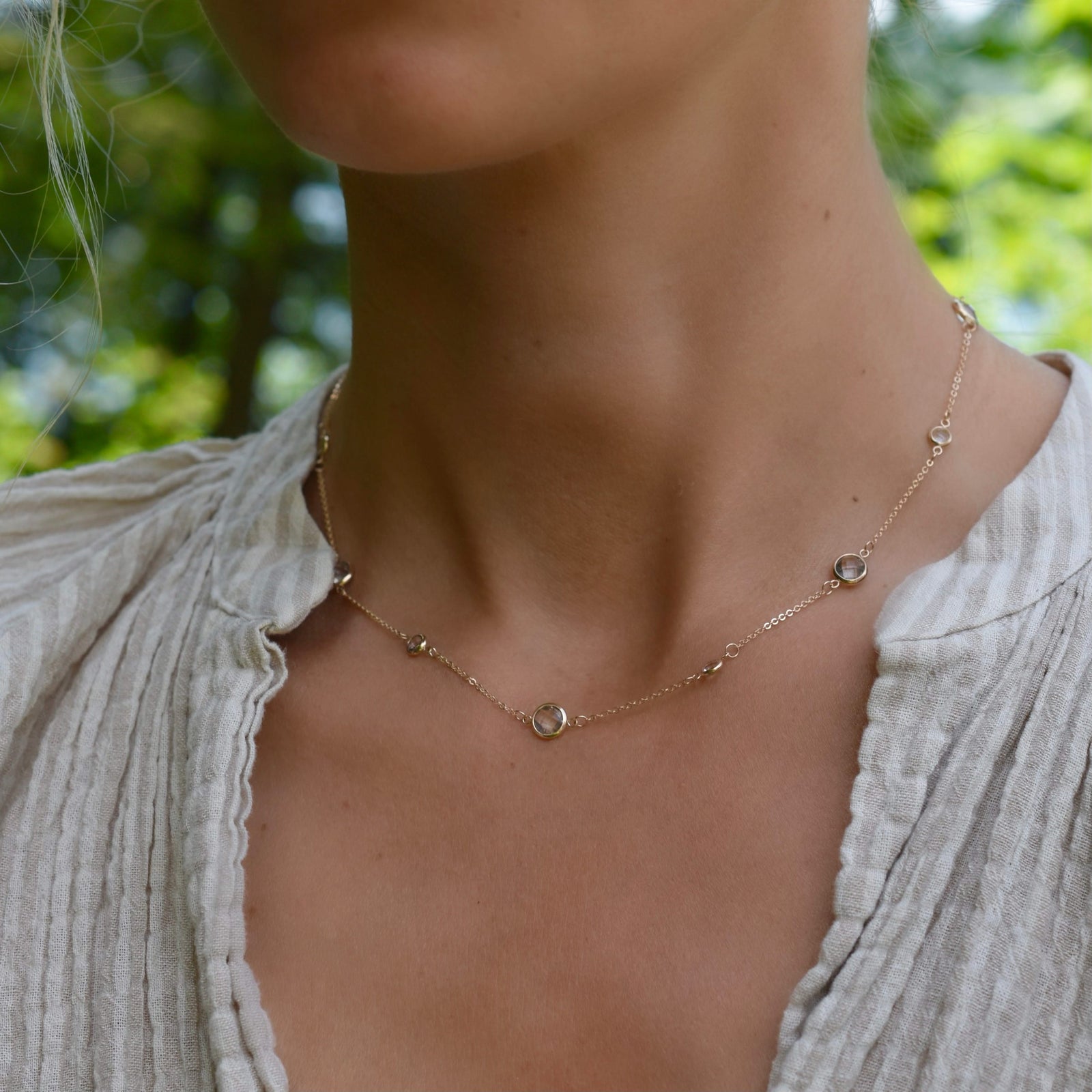 Woman wearing a Bayberry Grand & Classic 14k gold necklace featuring alternating 4 mm and 6 mm briolette cut White Topaz