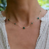 Woman with a Bayberry Grand & Classic 14k yellow gold necklace featuring alternating 4 mm and 6 mm briolette cut emeralds