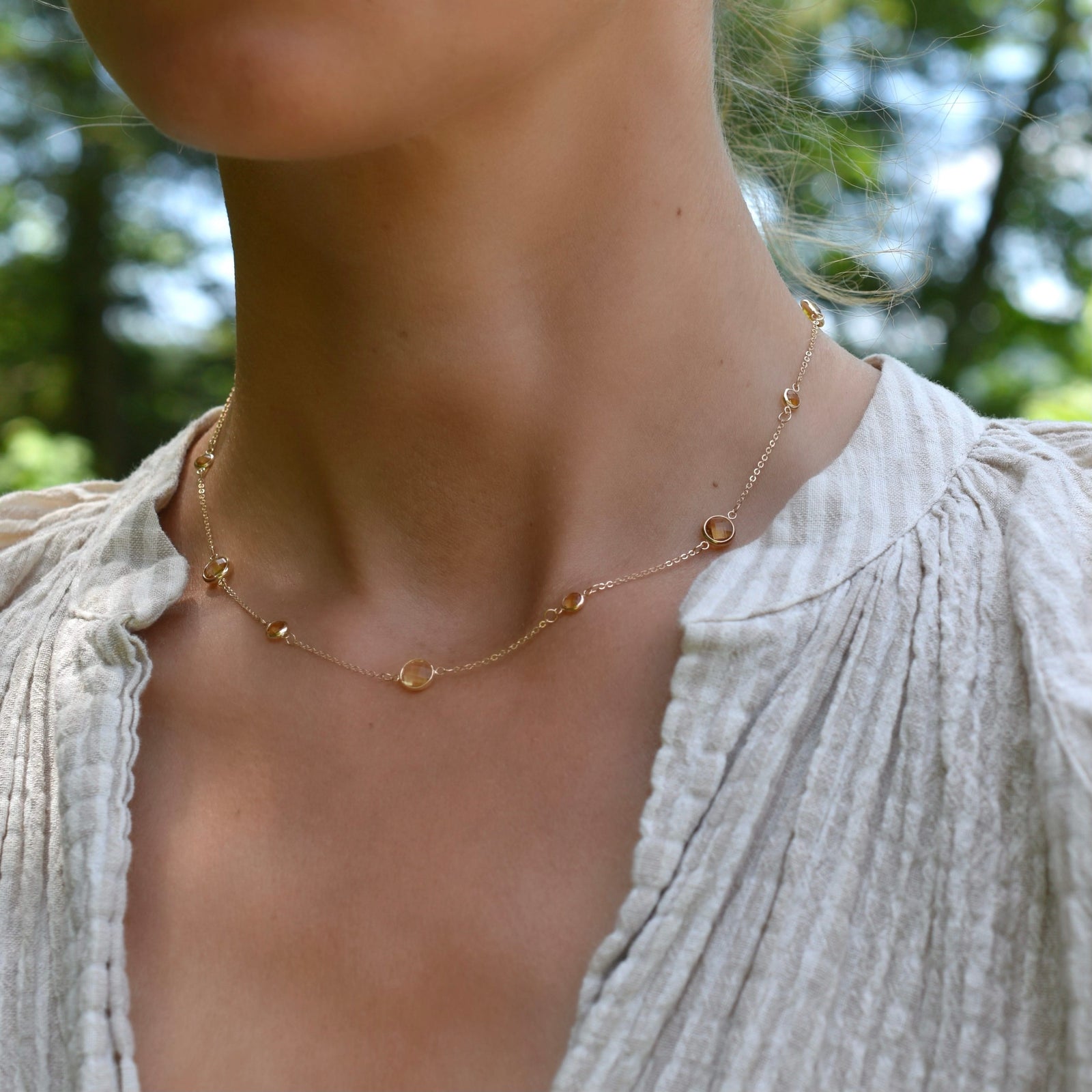 Woman wearing a Bayberry Grand & Classic 14k yellow gold necklace featuring alternating 4 mm and 6 mm briolette cut citrines