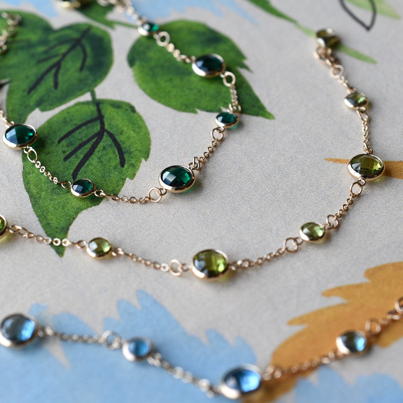 Several Bayberry Grand & Classic cable chain bracelets in 14k gold featuring alternating 4 mm and 6 mm gemstones