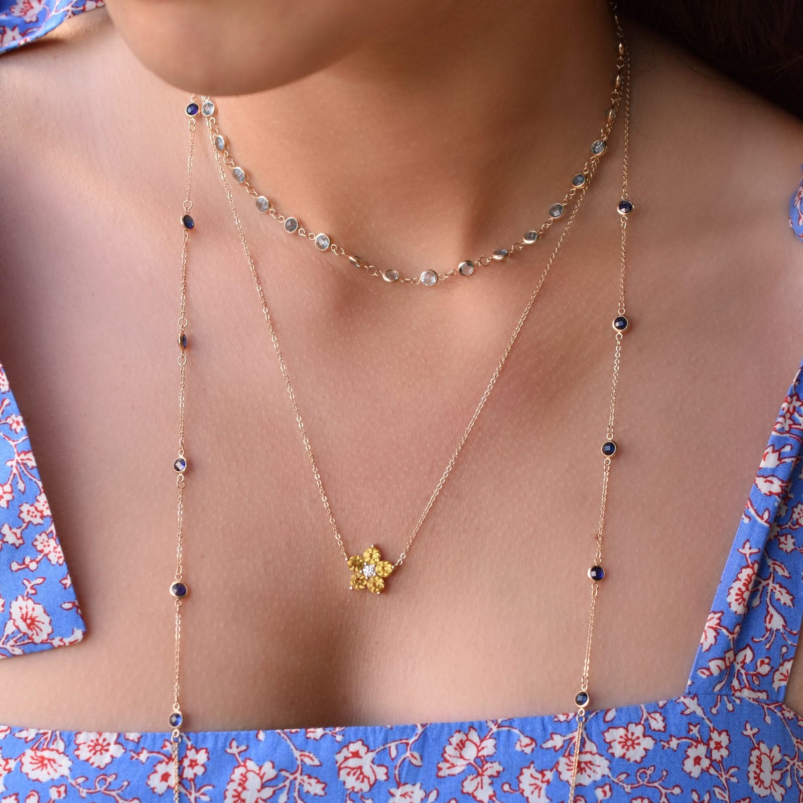 Woman wearing layered 14k gold necklaces including a Greenwich necklace featuring five 4 mm citrines and one 2.1 mm diamond