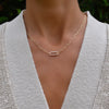 Woman with a 14k yellow gold Adelaide paperclip chain necklace featuring one link encrusted with 1.5 mm pavé diamonds