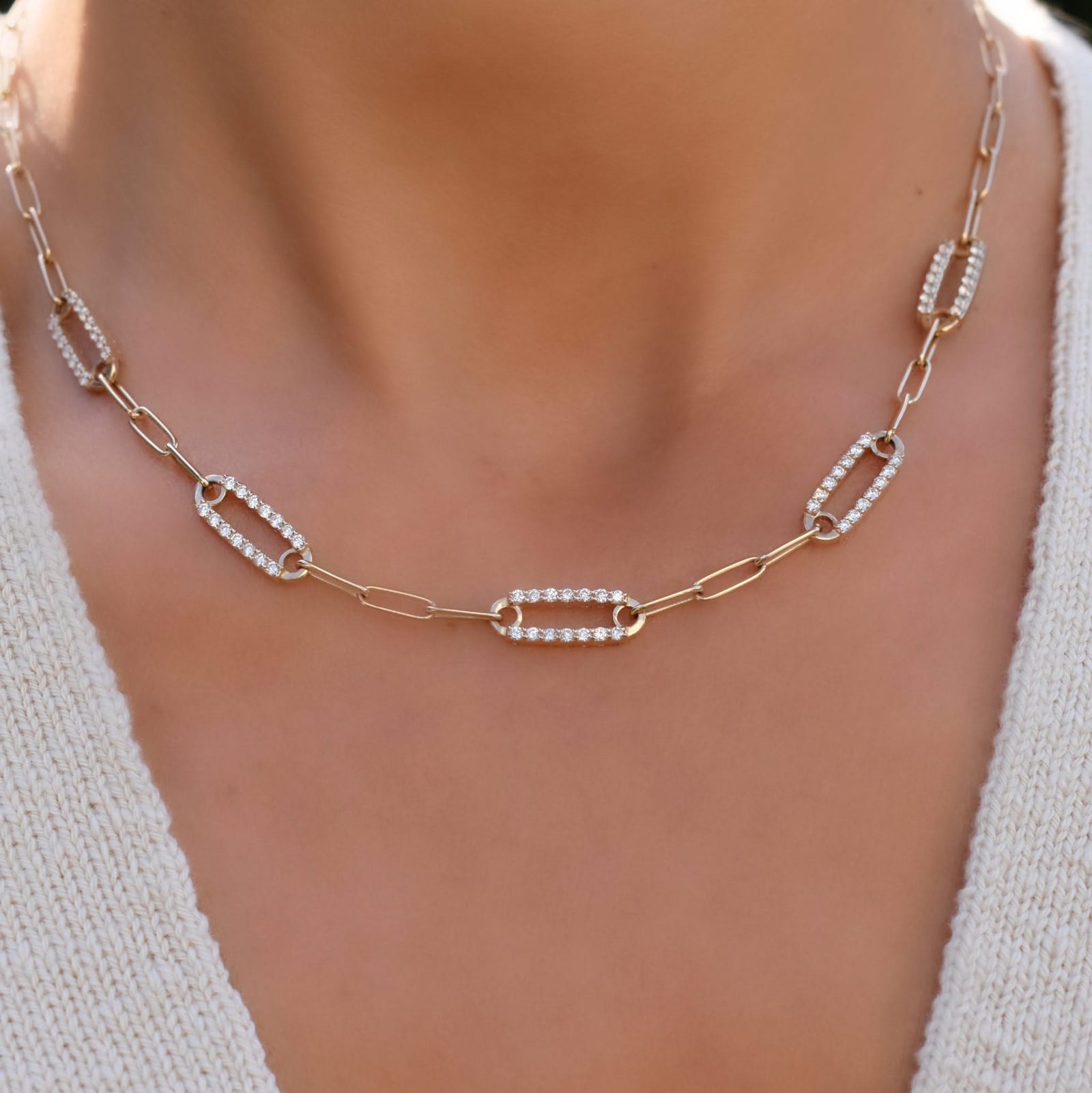 Woman with a 14k yellow gold Adelaide paperclip chain necklace featuring five links encrusted with 1.5 mm pavé diamonds