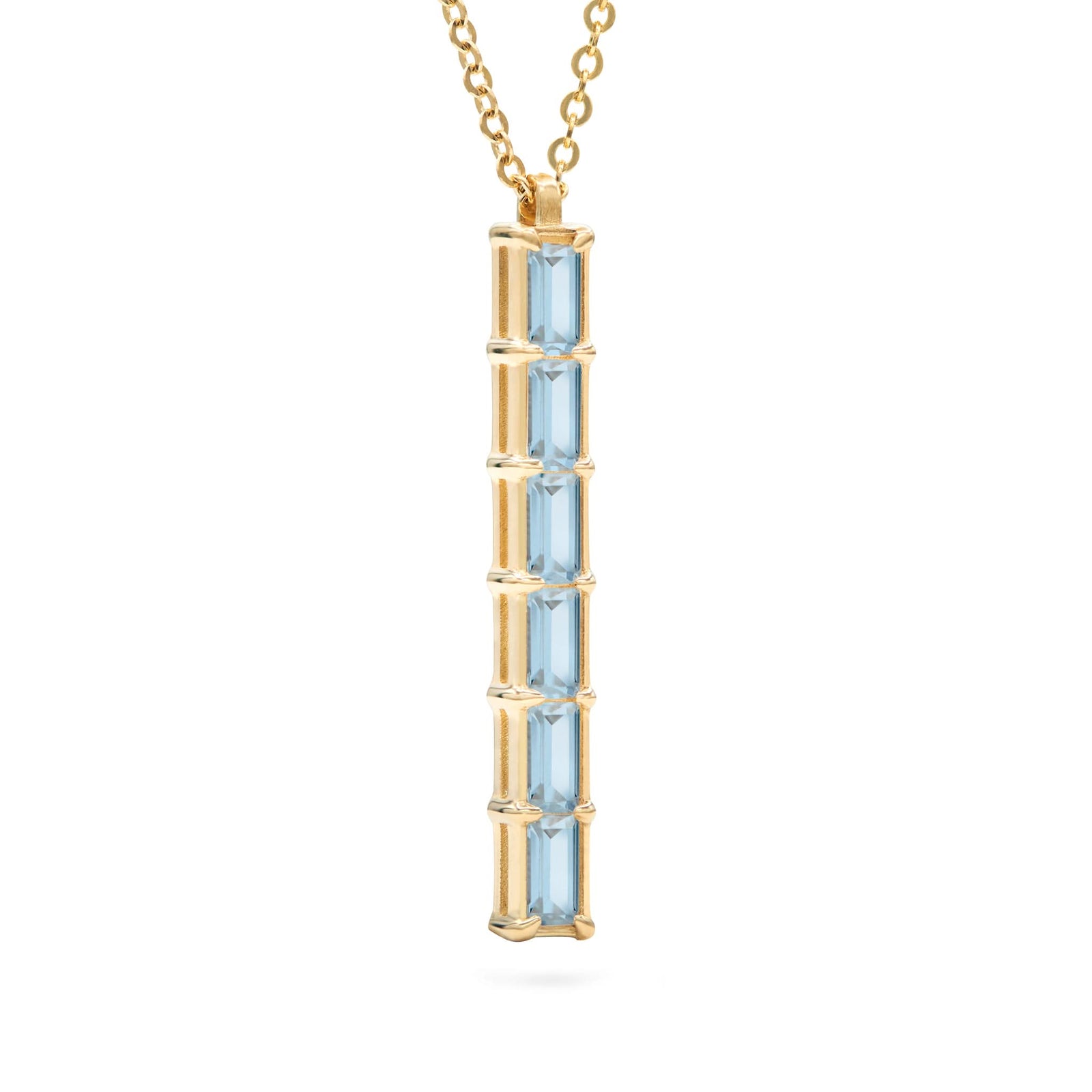 Providence vertical bar pendant featuring 6 petite Nantucket Blue Topaz baguette stones set in 14k yellow gold - angled view