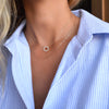 Woman with two necklaces including a Rosecliff small circle necklace featuring twelve 2mm diamonds prong set in 14k gold