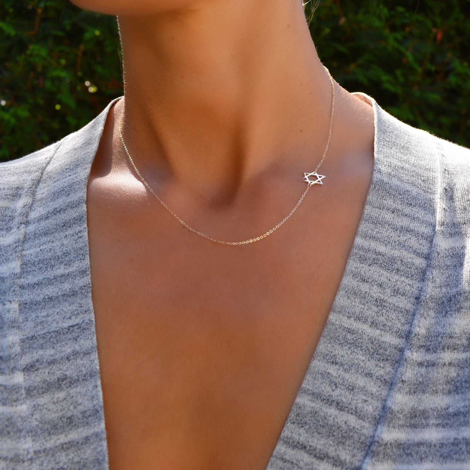 Woman wearing a 14k yellow gold cable chain Classic necklace featuring a 1/2" cutout Star of David