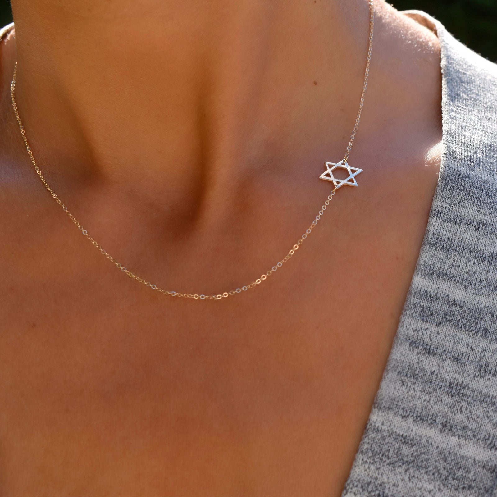 Woman wearing a 14k yellow gold Classic necklace featuring a 1/2" cutout Star of David