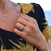 Woman wearing assorted jewelry including a Warren ring in 14k gold with diamonds featuring one 10 x 8 mm lemon verbena quartz