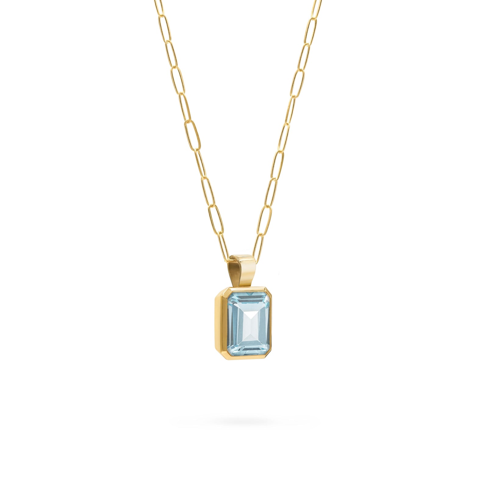 Adelaide paper clip chain and a Warren pendant with an emerald cut Nantucket blue topaz gemstone in 14k gold - angled view