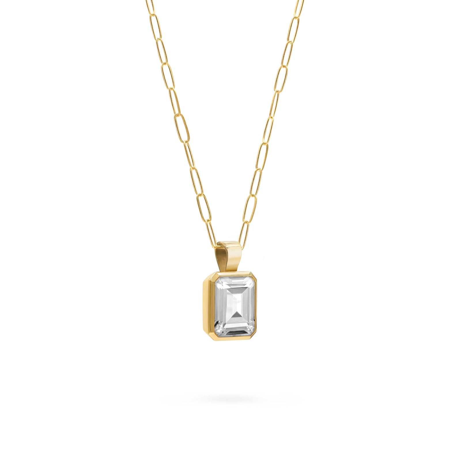 Adelaide paper clip chain and a Warren pendant with an emerald cut bezel set white topaz gemstone in 14k gold - angled view