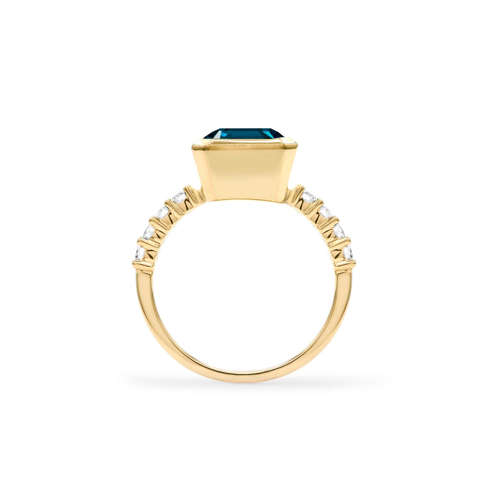 Warren ring in 14k yellow gold with accent diamonds featuring one 10 x 8 mm emerald cut Atlantic Blue Topaz - standing view