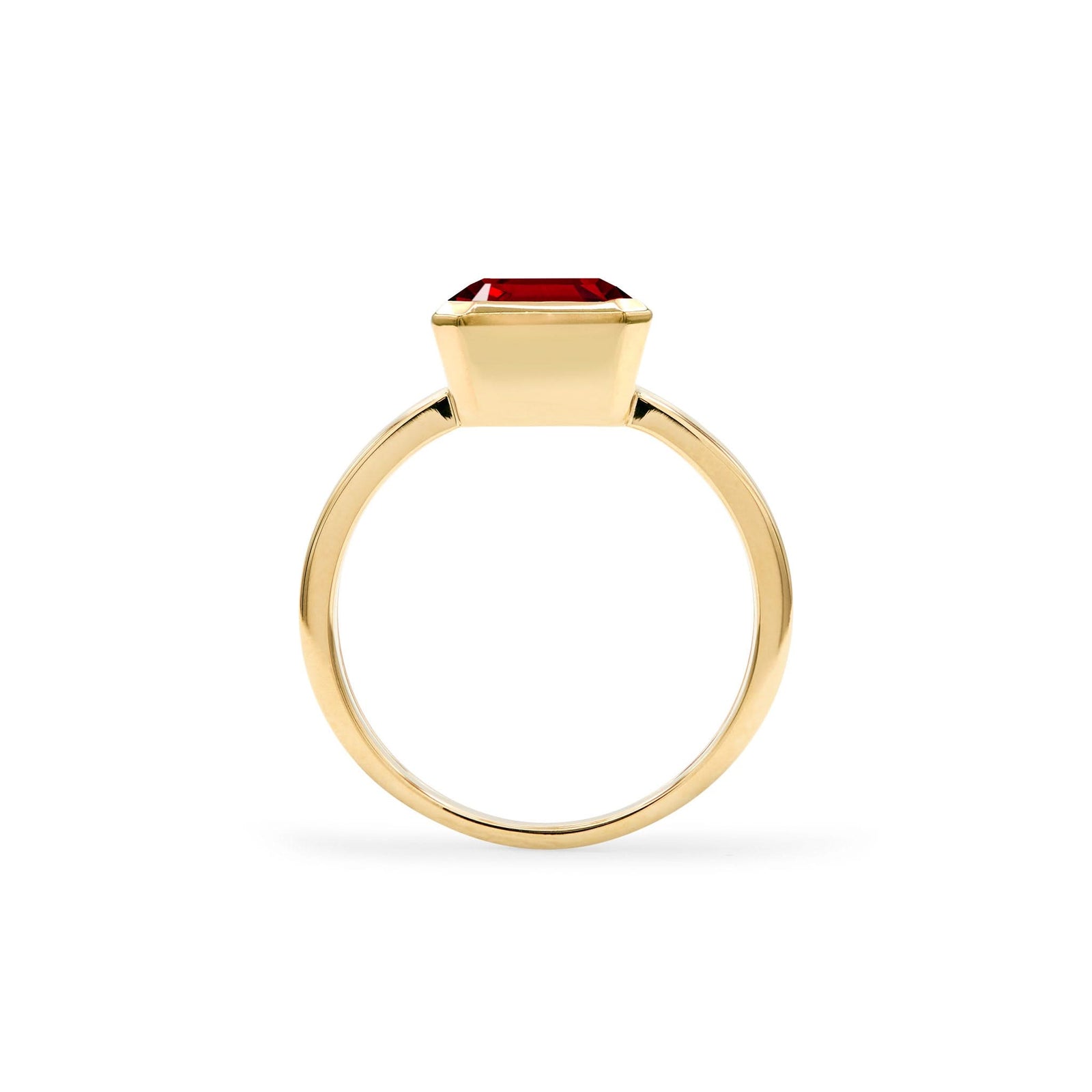 Warren ring in 14k yellow gold featuring one 10 x 8 mm emerald cut bezel set garnet - standing view