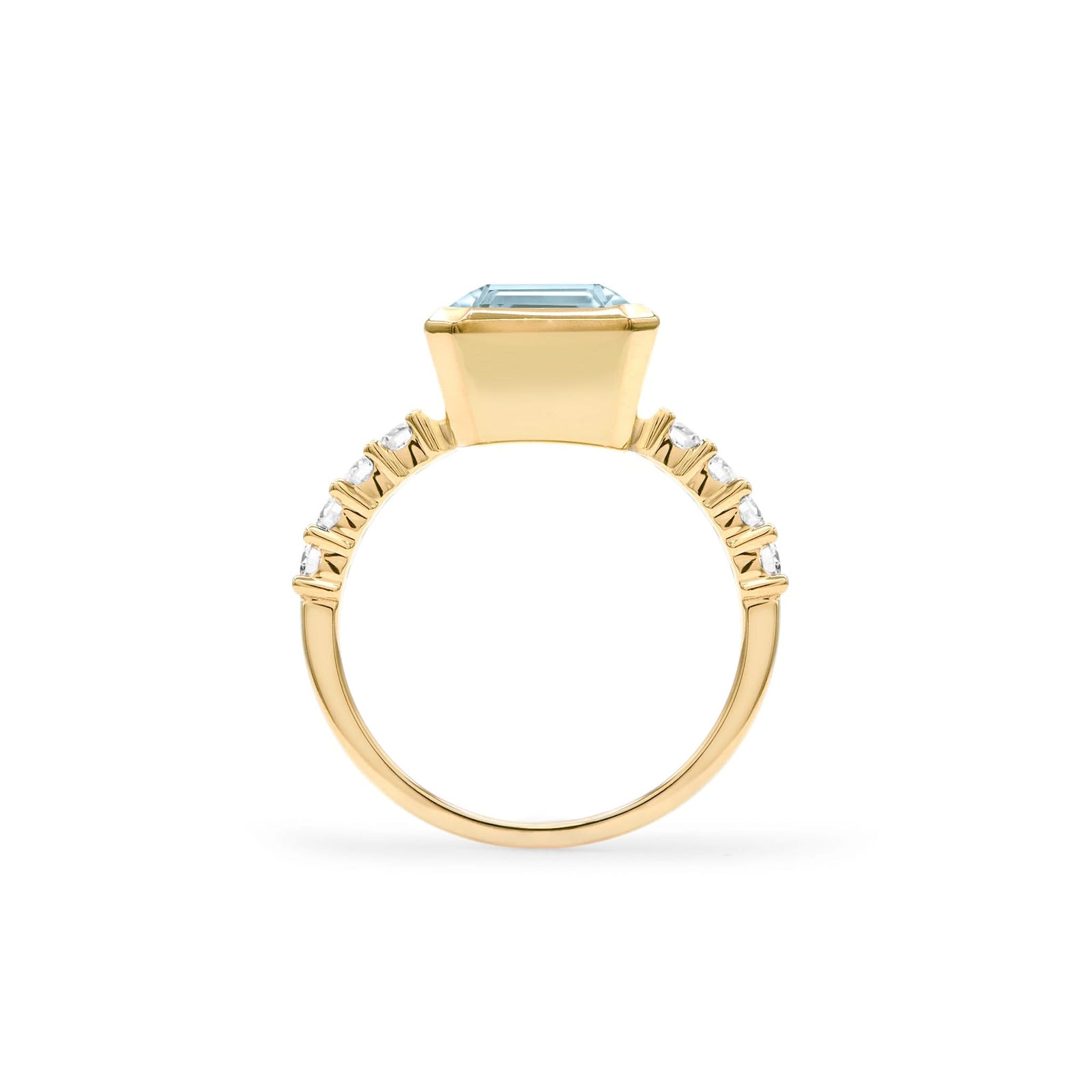 Warren ring in 14k yellow gold with accent diamonds featuring one 10 x 8 mm emerald cut Nantucket blue topaz - standing view