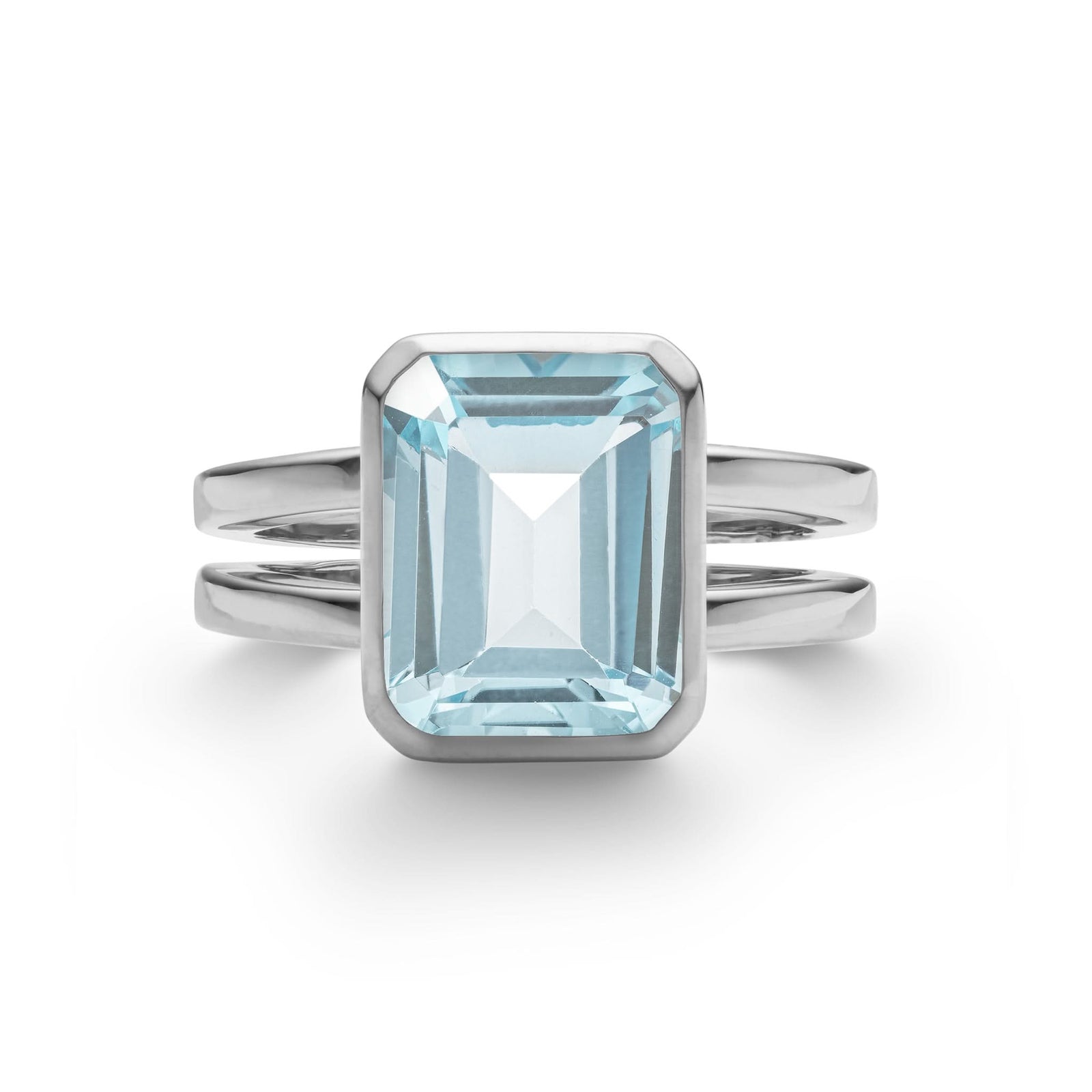 Warren ring in 14k white gold featuring one 10 x 8 mm emerald cut bezel set Nantucket blue topaz - front view