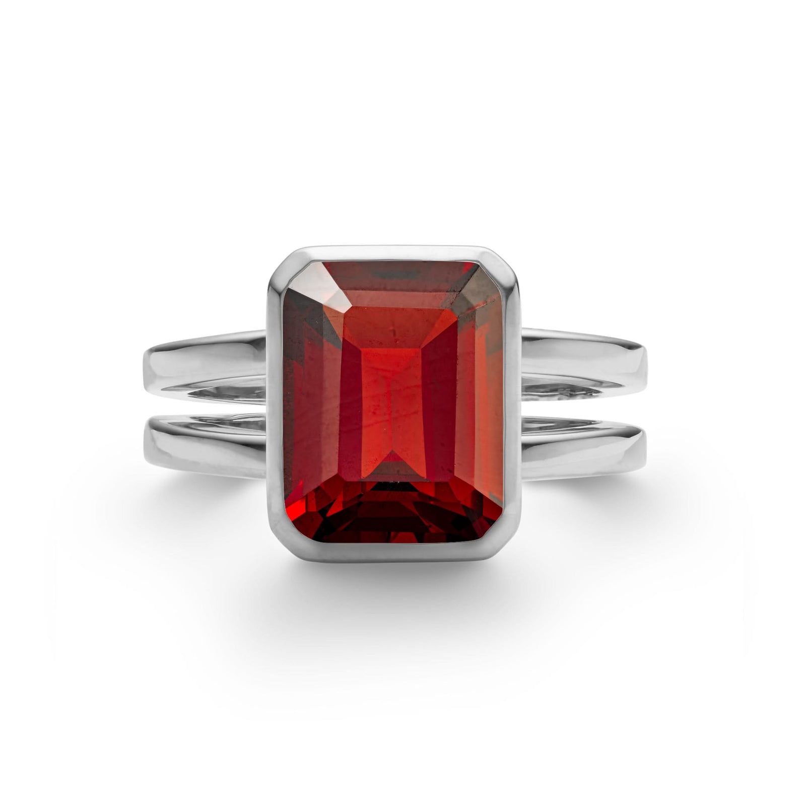 Warren ring in 14k white gold featuring one 10 x 8 mm emerald cut bezel set garnet - front view