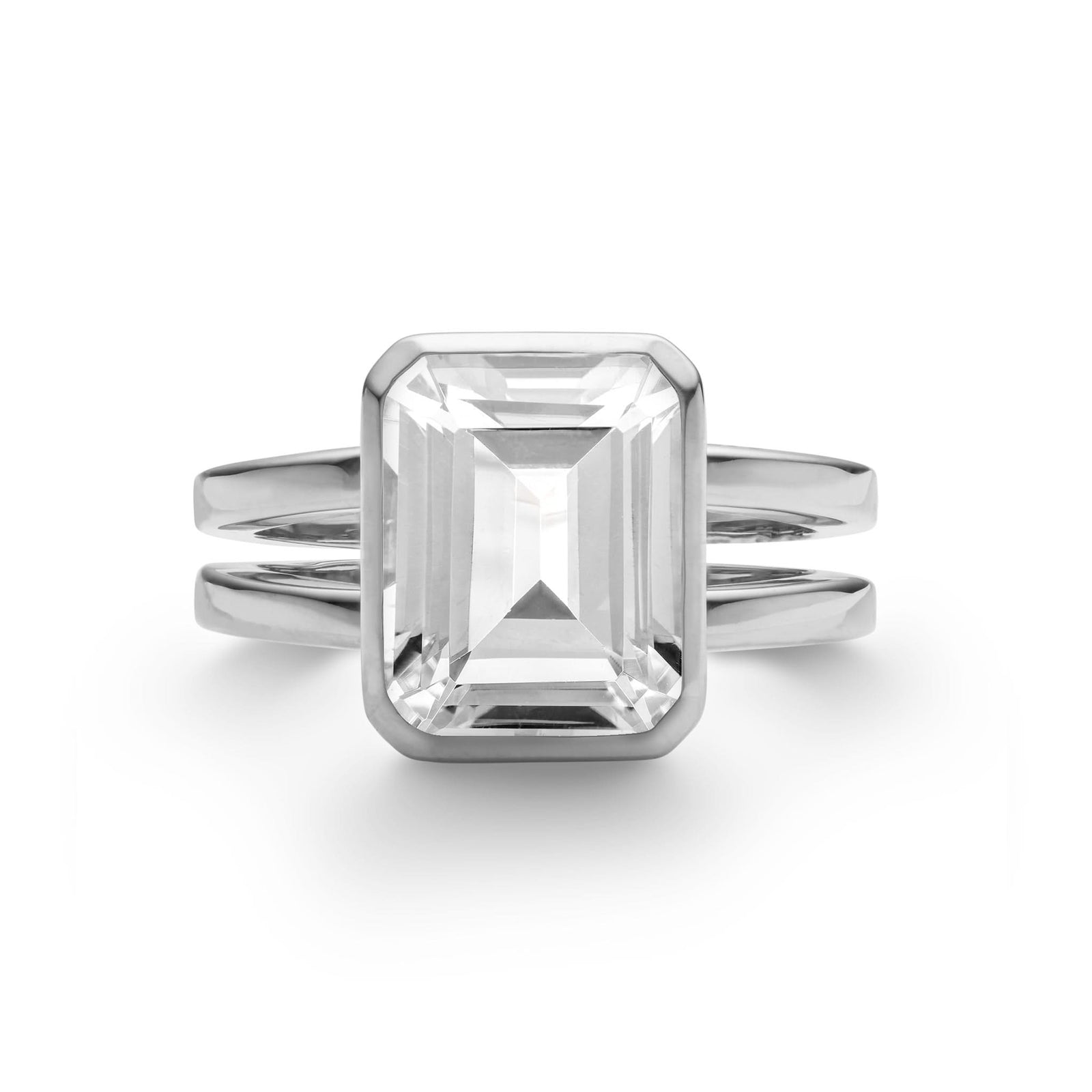 Warren ring in 14k white gold featuring one 10 x 8 mm emerald cut bezel set white topaz - front view